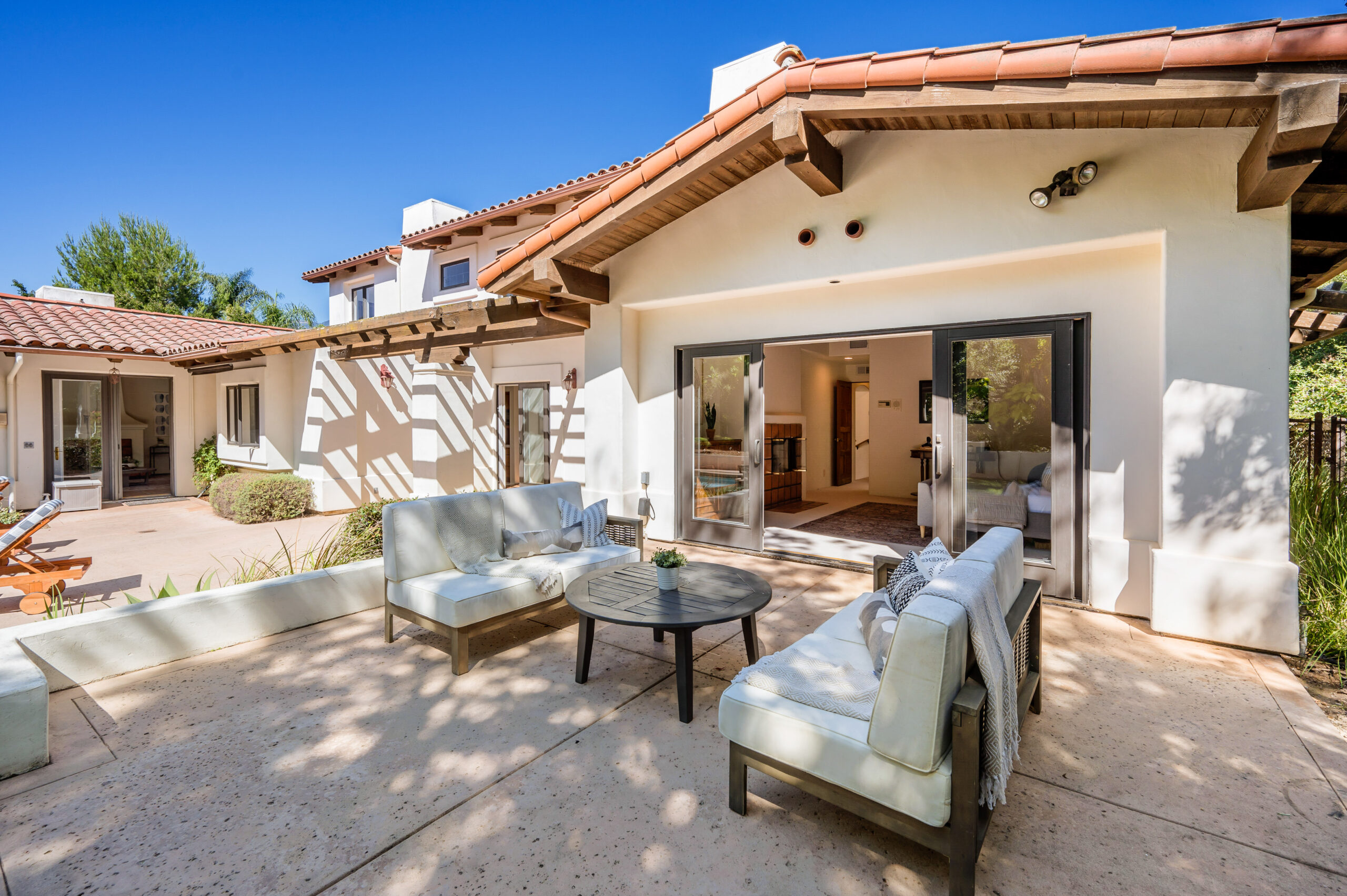 a-patio-with-furniture-and-large-glass-doors-that